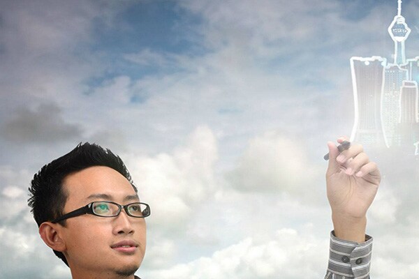 A man using a stylus on a smart screen to outline a graphical cityscape