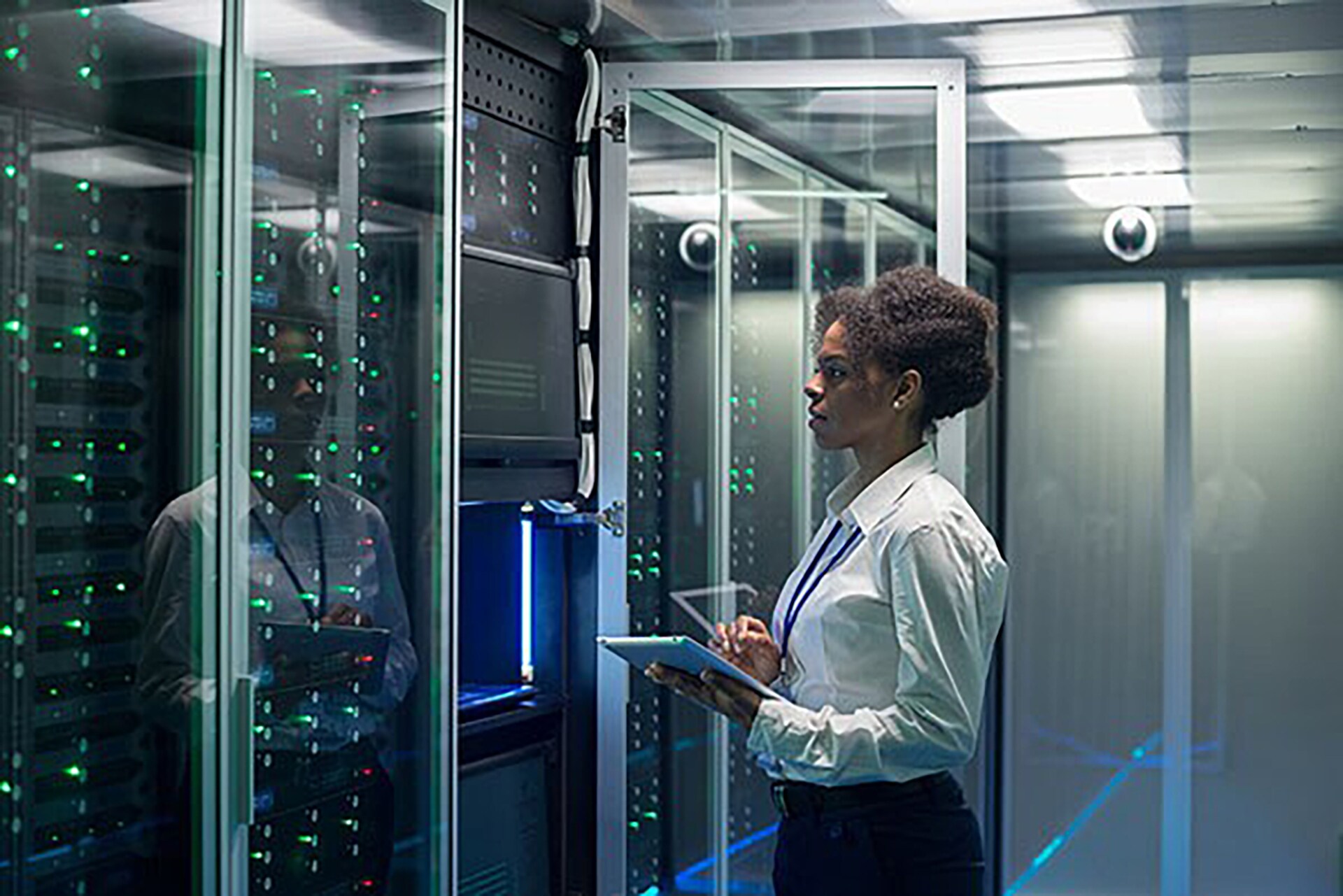 Lady looking at machine and writing on Tab