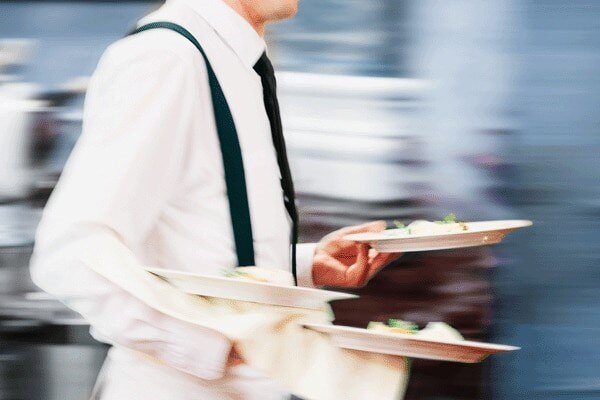 Close up of a waiter holding the plates for serving