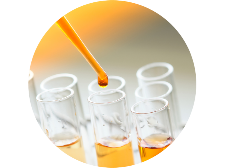 Closeup of a chemical drop falling from pipette to the test tube