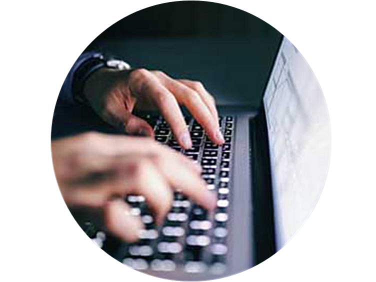 Close-up of a employees hand working on the laptop