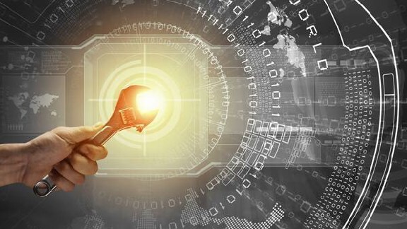 Close up of a hand holding a spanner with bright focus light in background overlaid with graphics of binary numbers