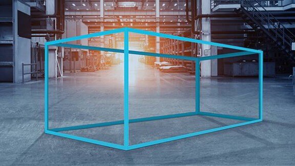 A blue box positioned in an industrial setting, surrounded by machinery and concrete structures