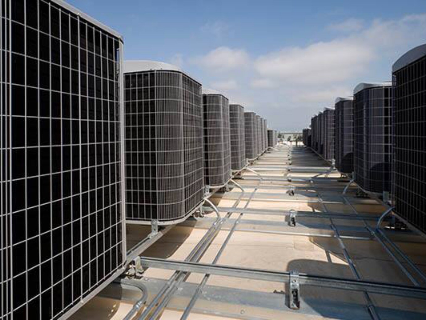 A row of air conditioning units installed on a rooftop