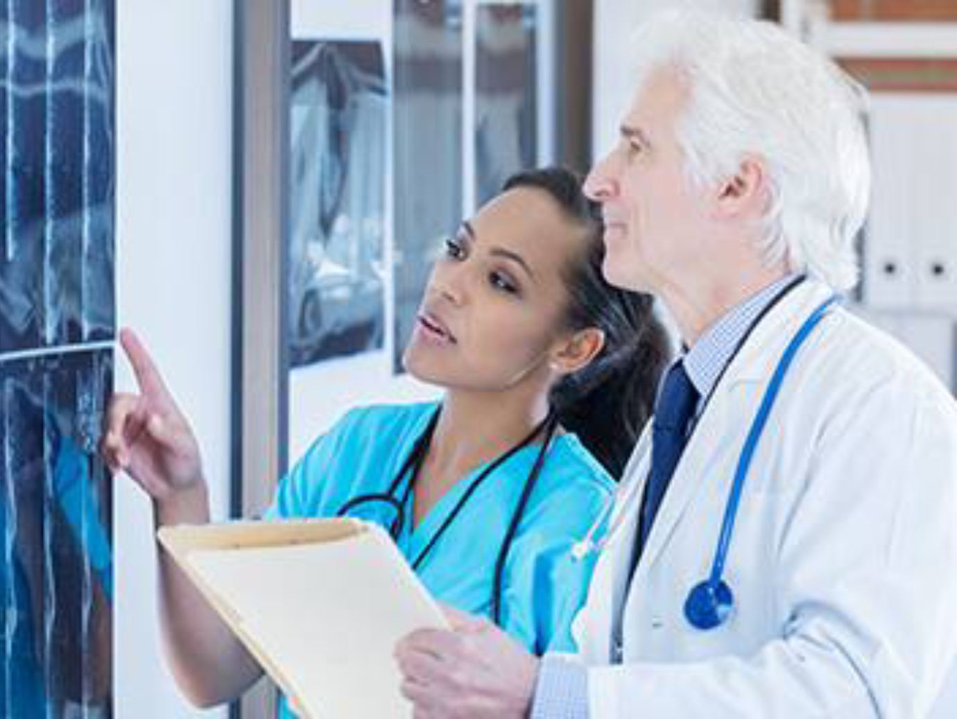  A doctor and a nurse examining an X-ray together