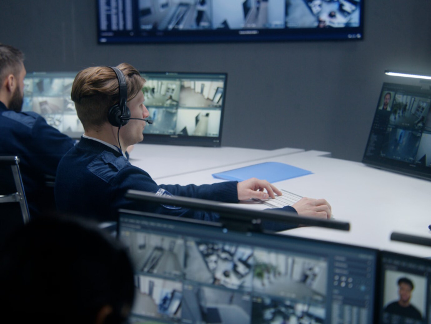 Security team members watching monitors