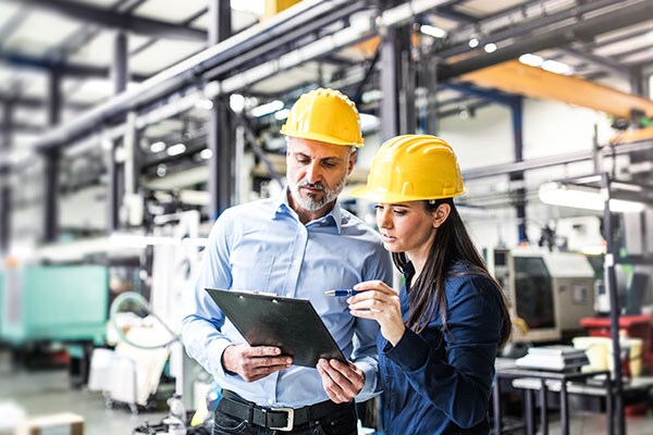 Two construction workers looking at the tab and analysing the data