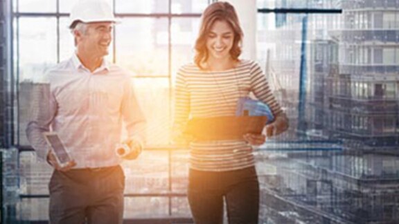 Two architects looking at the tab and discussing work