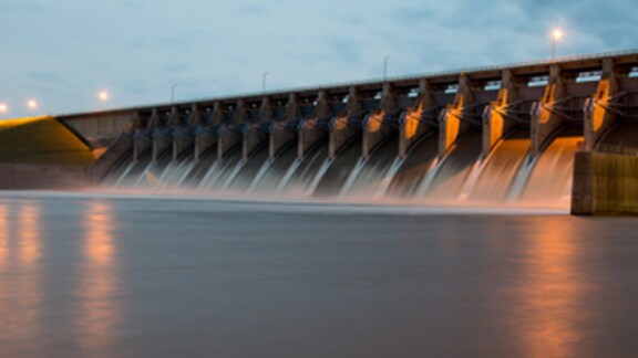 A view of the opened dam gates with water flowing out