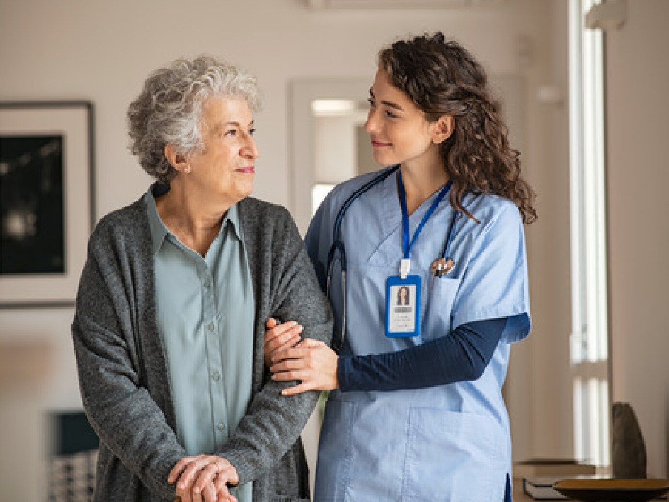 Caregiver assist senior woman at home