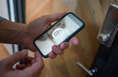 A person holding a mobile displaying a lock