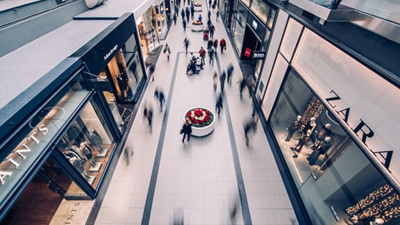 Aerial view of the interior of a shopping mall, with people walking inside