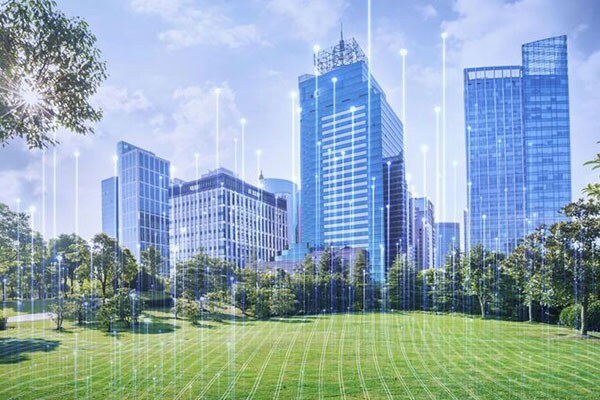 Front view of blue city scrapper across the green lawn overlaid with graphics of transmission nodes