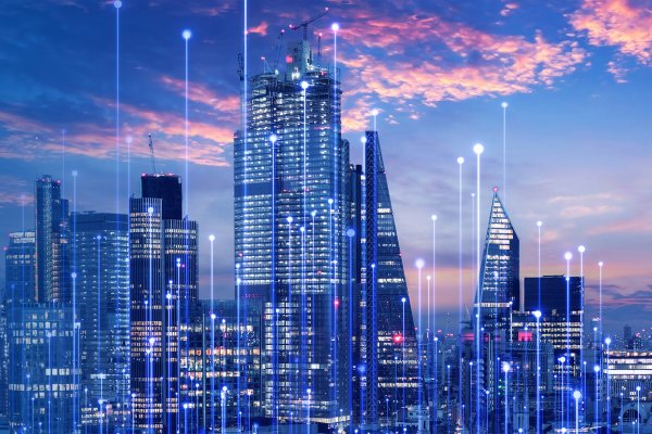 Futuristic city skyline with tall skyscrapers illuminated by blue lights